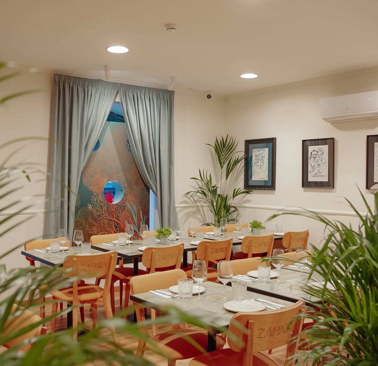 Dining room with set tables and plants