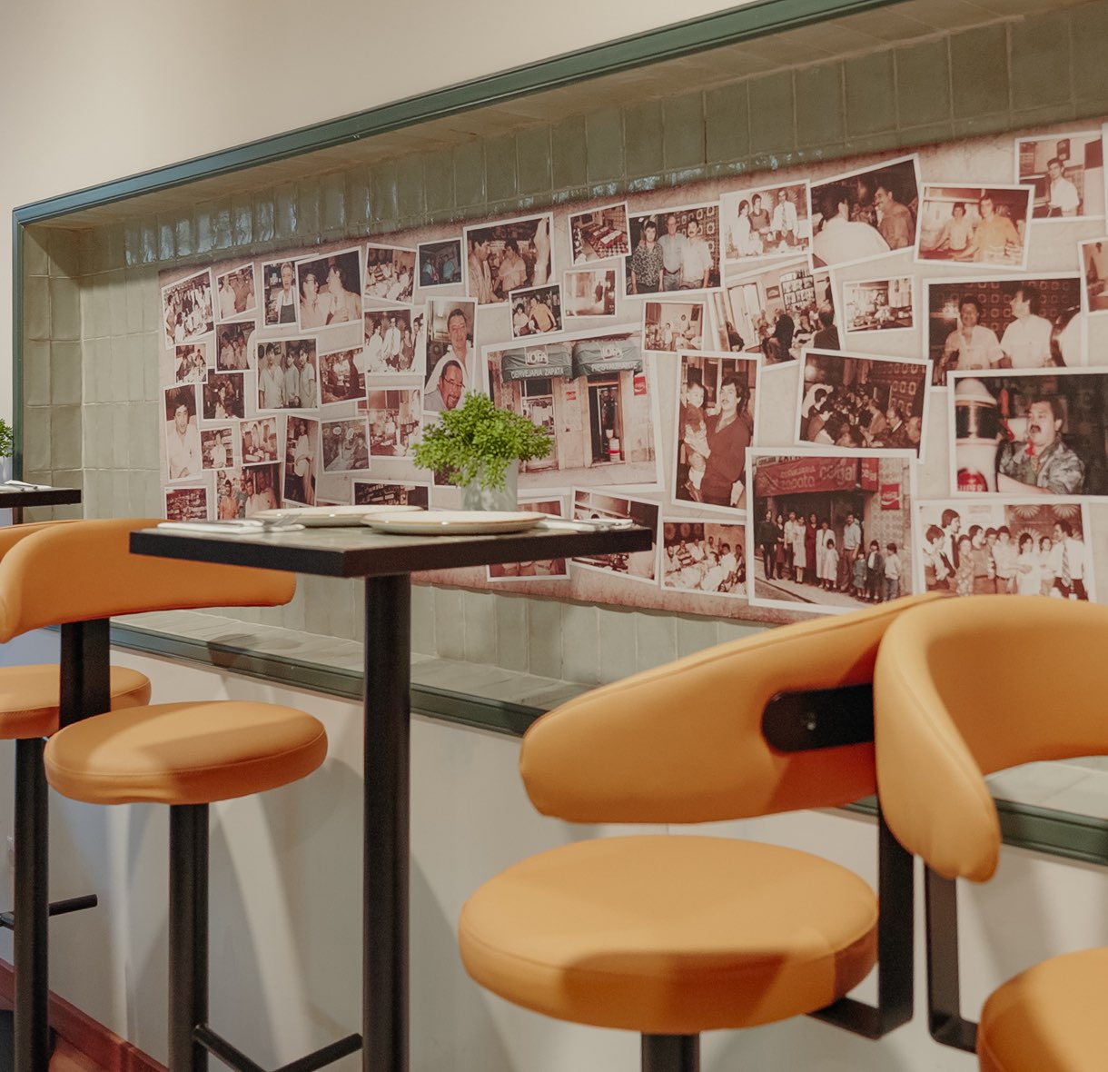 High stools by the wall of photographs of the Cervejaria Zapata families