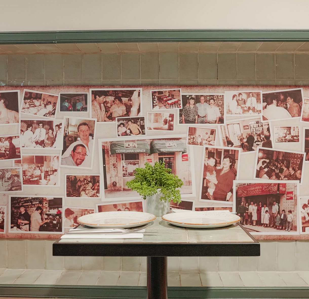 Table set in front of the wall of family photographs
